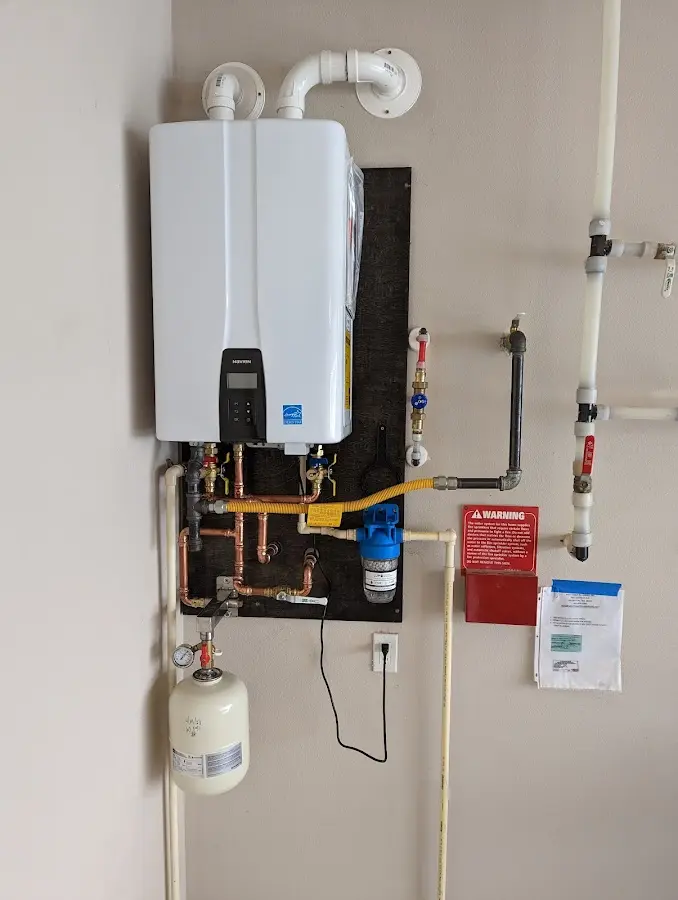 Professional plumber installing copper piping in a Chanute home